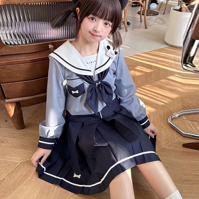 Puppy Jirai Kei sailor uniform front three-quarter sitting pose featuring removable puppy brooch white-trimmed pleated skirt bone embroidery cafe environment twin tails