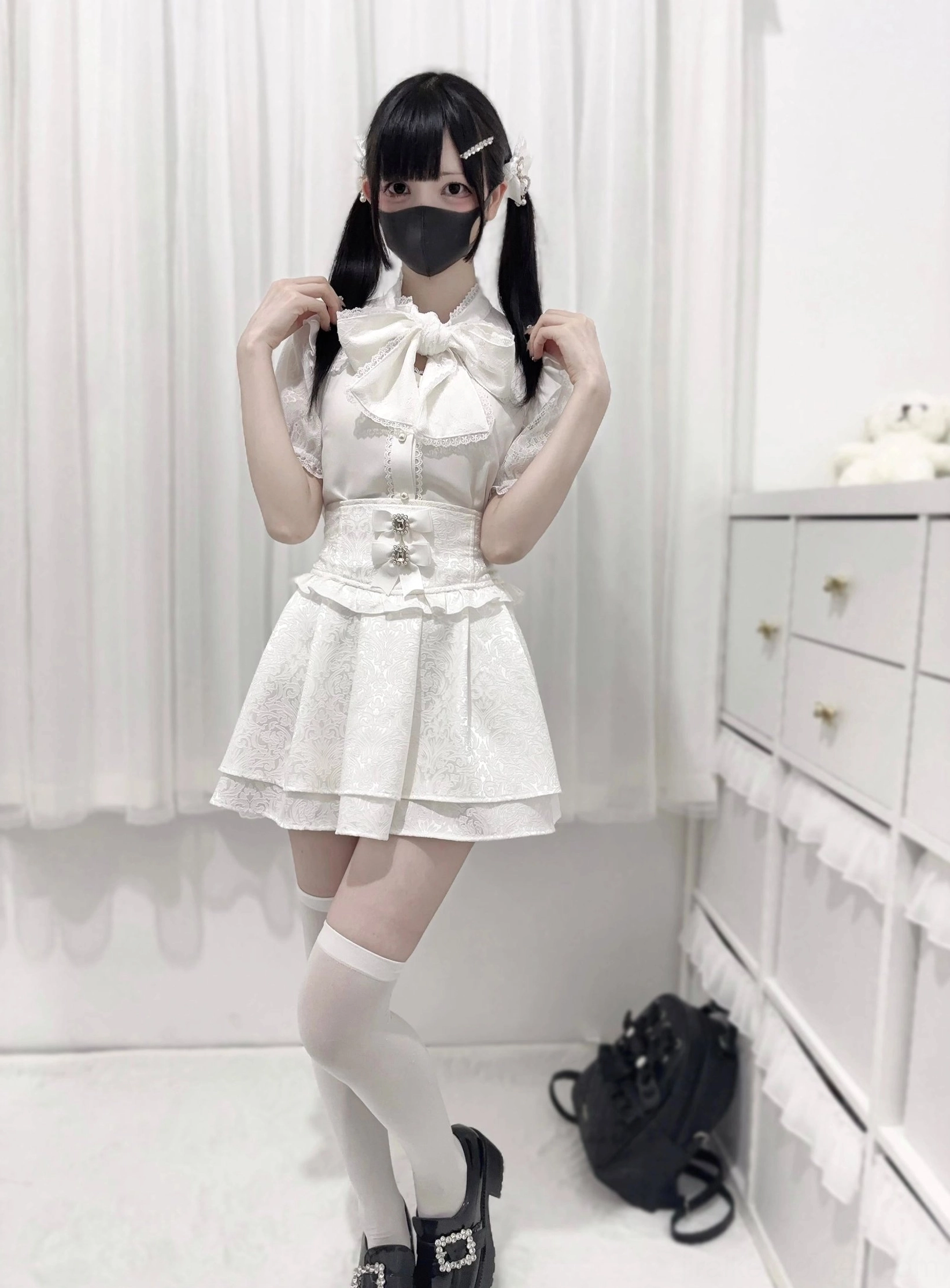 Pure white jirai kei lace short sleeve blouse with bow tie neckline side profile view model wearing thigh-high socks leather loafers