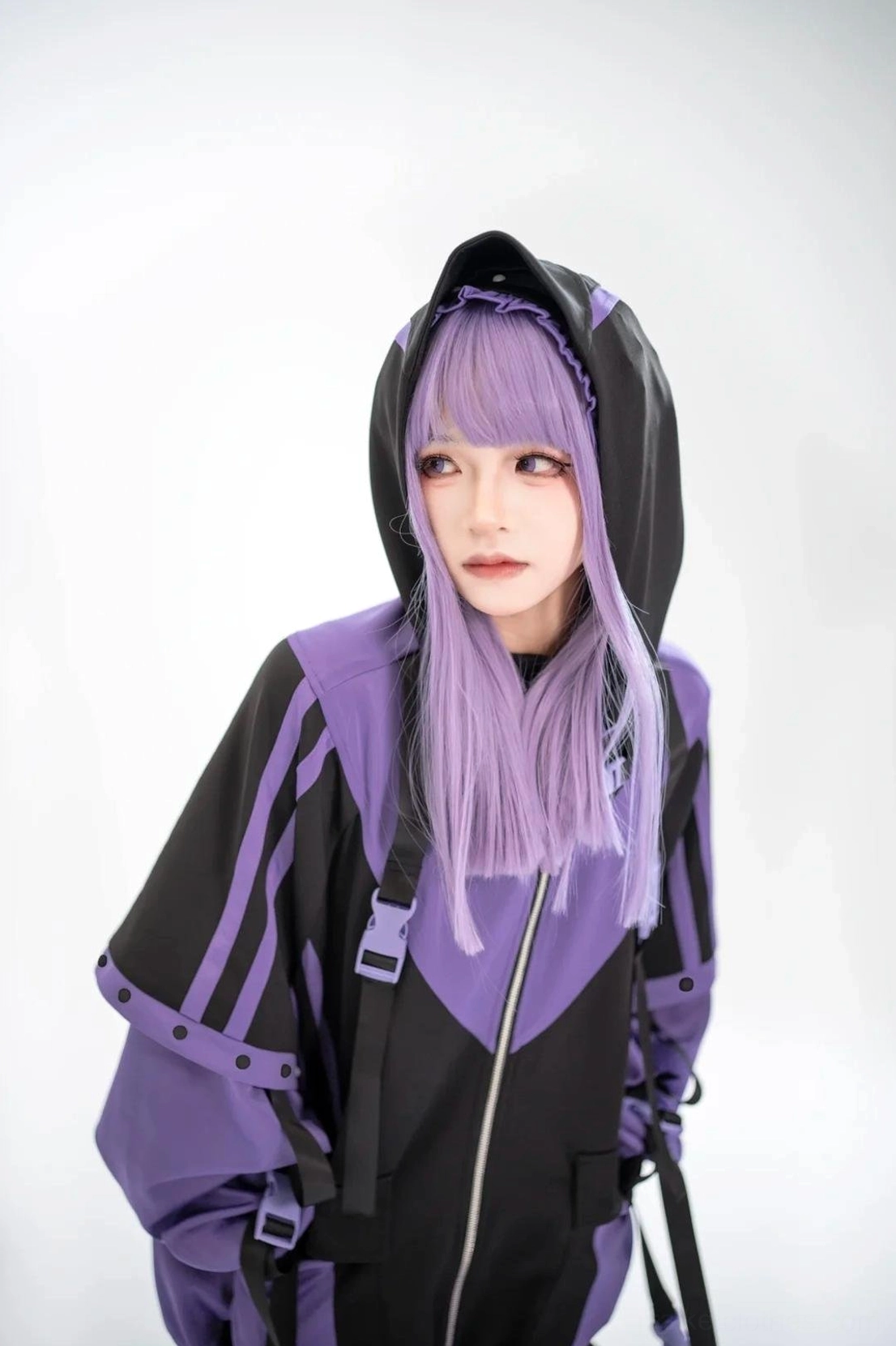Purple-black zip-up hooded sporty coat contrast stripe details strap accents color-block design close-up purple-haired model