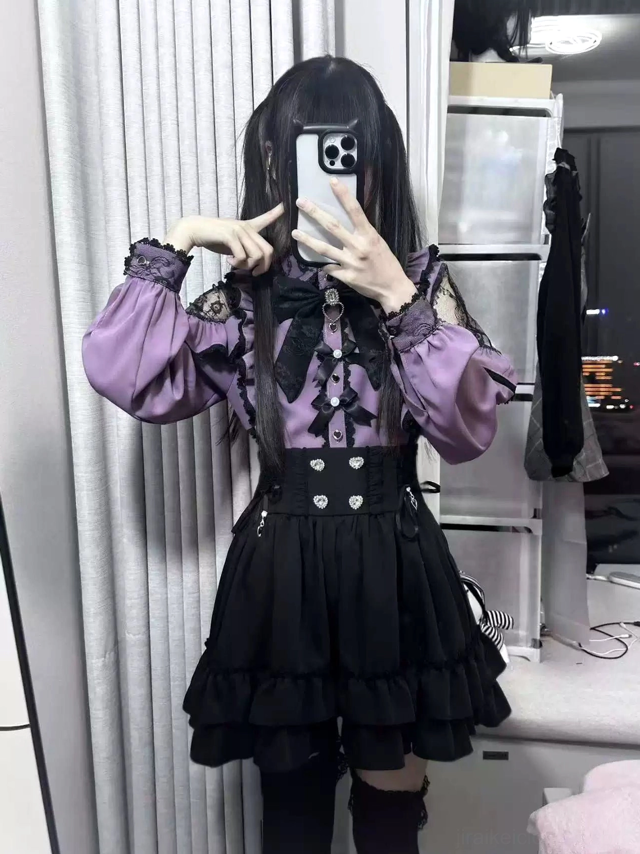 Purple Jirai Kei blouse detail showing large black neck bow and fitted ruffled short skirt aesthetic styling