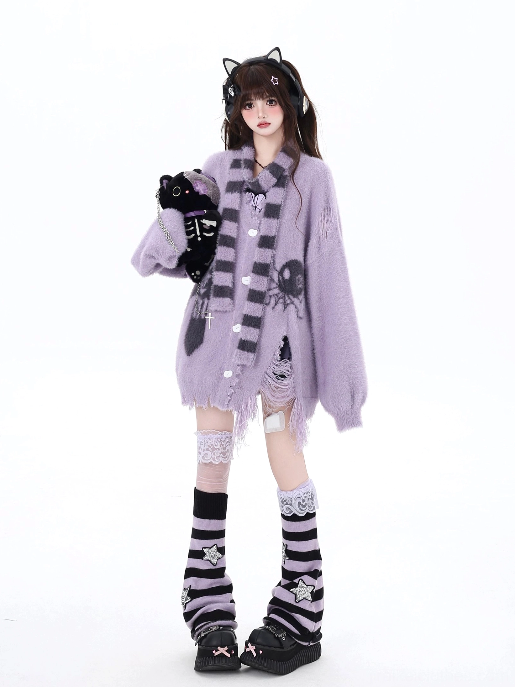 Light purple Jirai Kei ripped side cardigan with spider and skull prints, purple-grey striped scarf accessory, distressed asymmetrical hem detail, cat-ear headphone styling