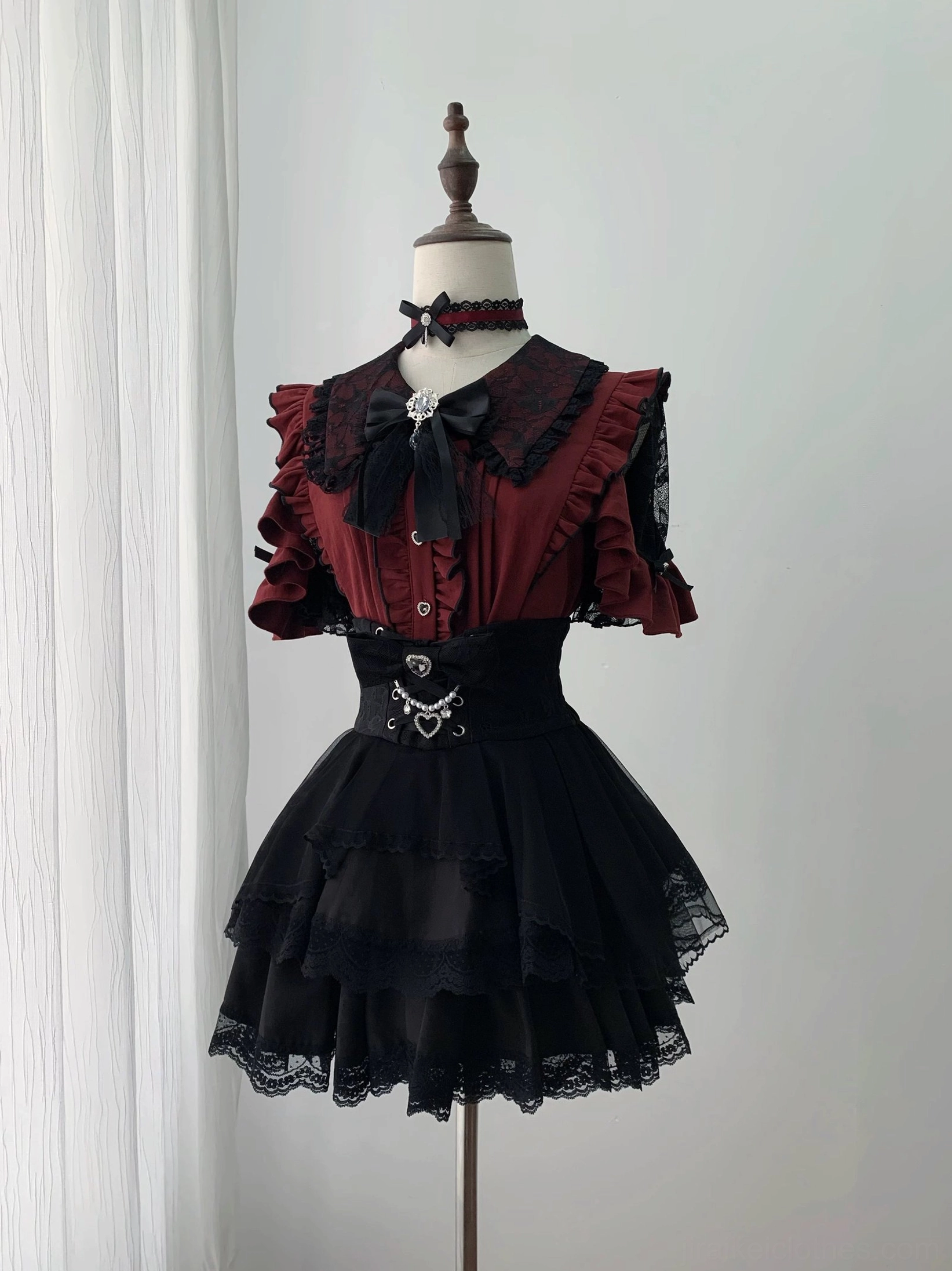 Red and black Jirai Kei blouse with ruffle short sleeves and lace-trimmed skirt front display view