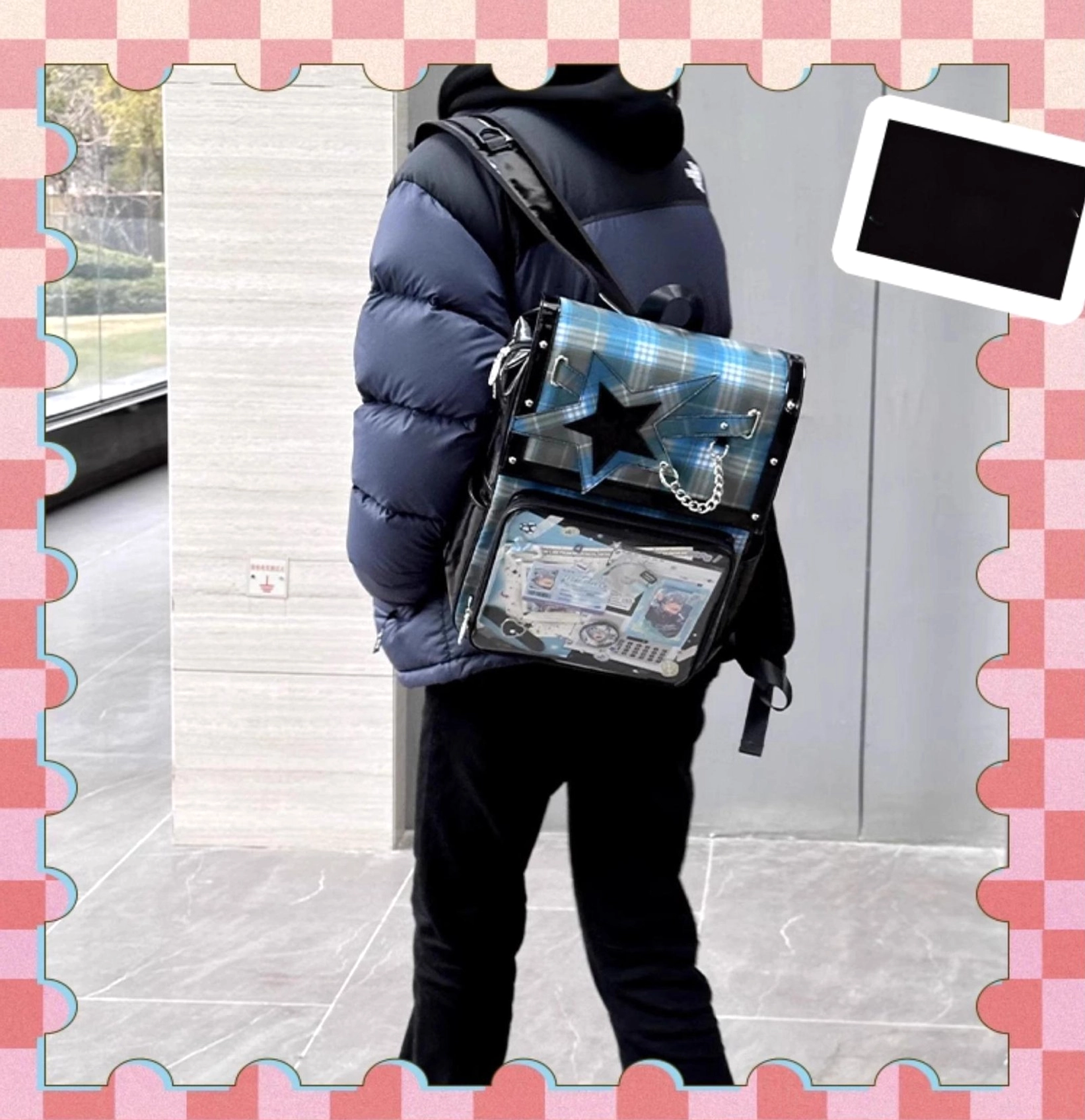 Red-black plaid star ita backpack flat lay highlighting star belt design and clear acrylic window
