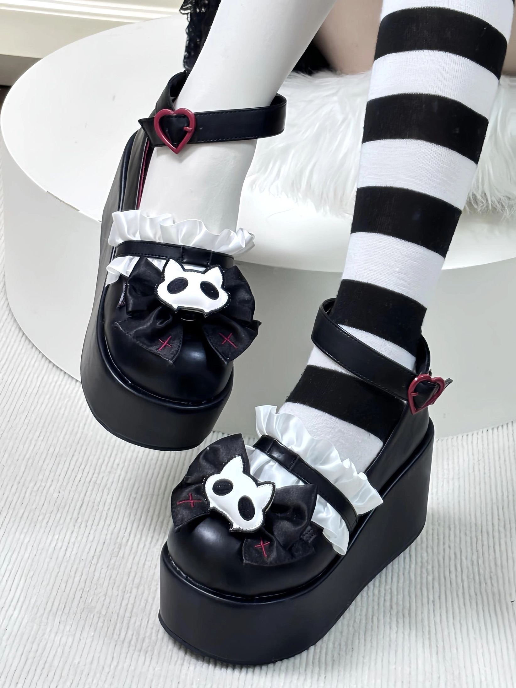 Red Jirai Kei gothic platform shoes with heart buckle and cat skeleton bow design top down side view