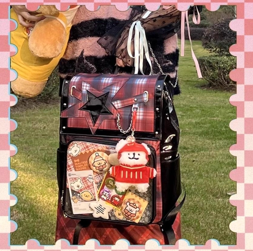 Red tartan plaid star ita backpack front flat view outdoor lawn setting with metal chain and display goods