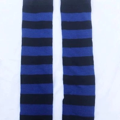 Royal blue and black striped over-the-knee socks flat lay display, bold contrasting horizontal stripes, white background