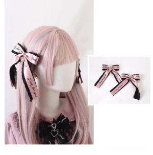 Ryousangata bow hair clips pair side view and flat lay showing pink and black printed ribbons matched set on pink mannequin head with pink blouse