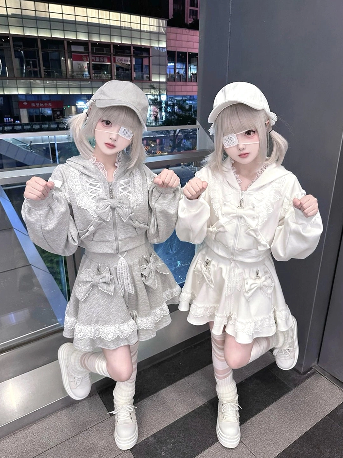 Front facing models wearing ryousangata lace hoodies with bow decorations and platform boots, jirai kei aesthetic newsboy caps