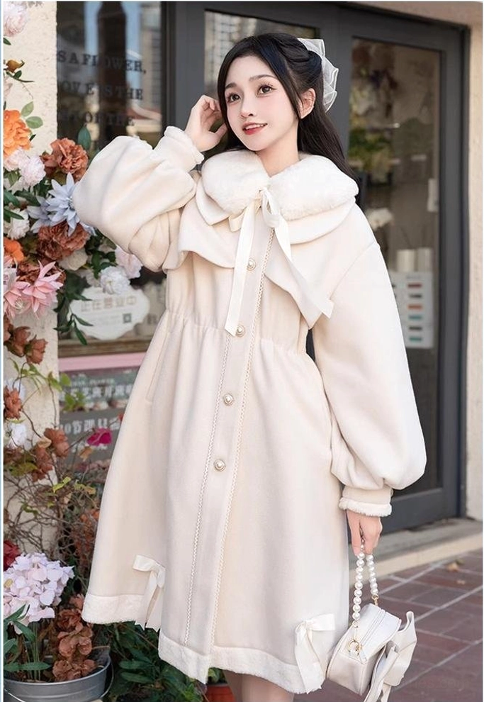 Beige Ryousangata Jirai Kei winter coat three-quarter view - girl holding bow handbag wearing light coat with fur collar and side hem bow details and lantern cuffs