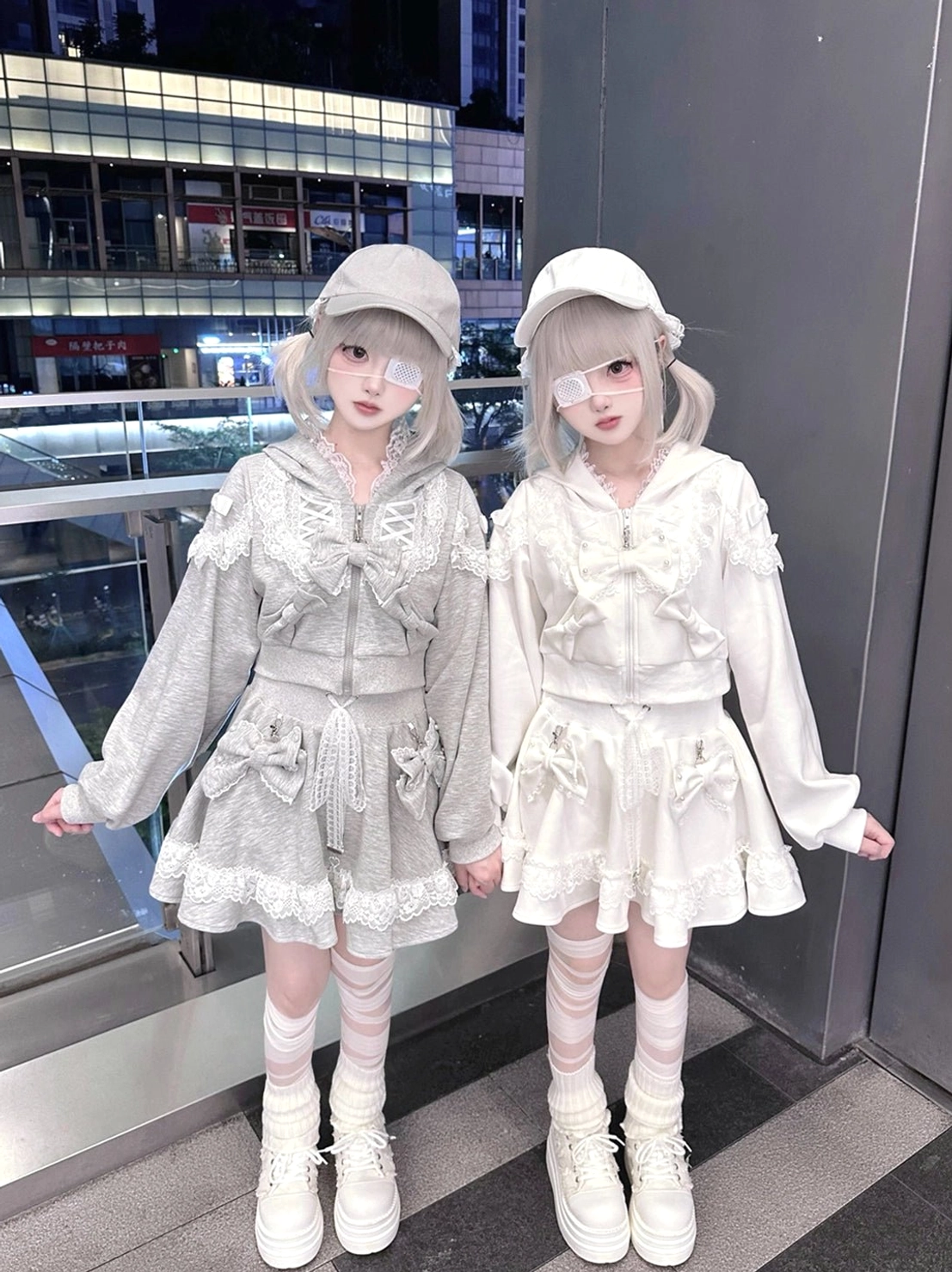 Long puff sleeve ryousangata hoodies with lace-trimmed skirts, high-angle front shot of twin models indoor mall area