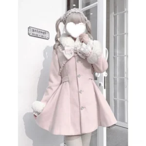 Ryousangata pink Jirai Kei winter coat front three-quarter view with detachable apricot faux fur collar and cuffs, dramatic lace bow chest piece, heart-shaped buttons, white glass storefront background