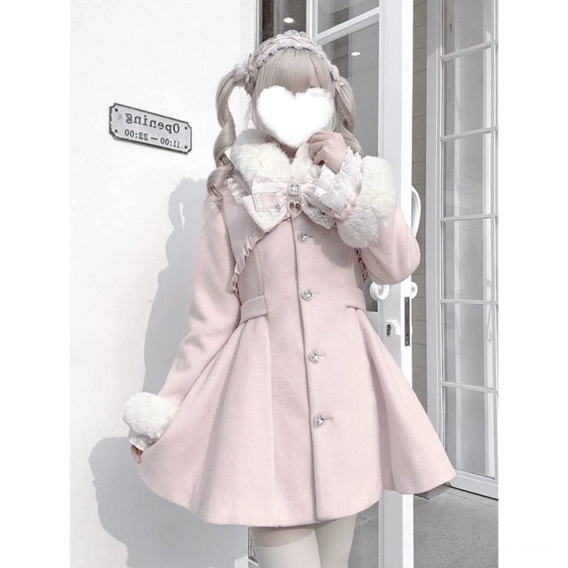 Ryousangata pink Jirai Kei winter coat front three-quarter view with detachable apricot faux fur collar and cuffs, dramatic lace bow chest piece, heart-shaped buttons, white glass storefront background