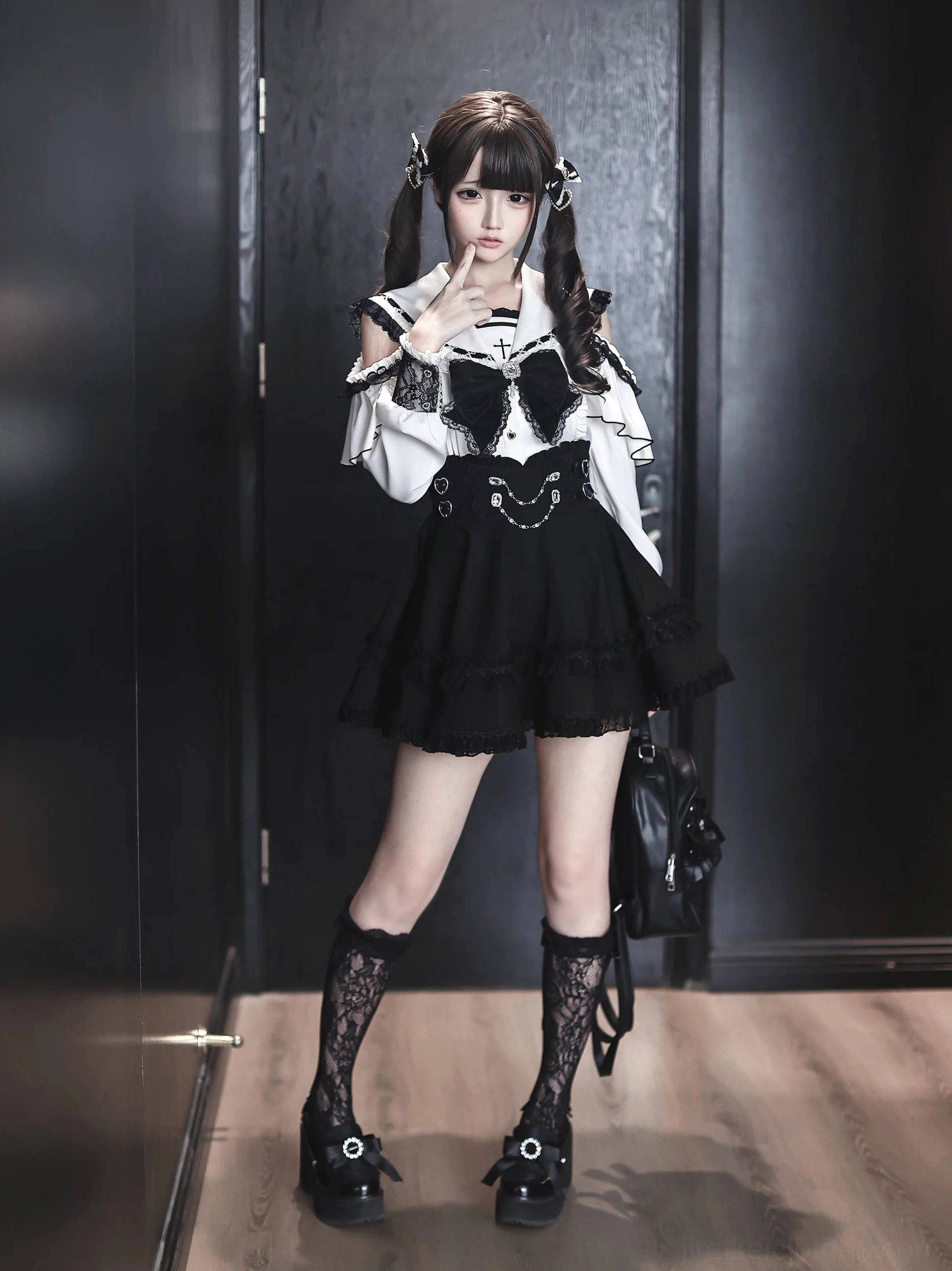 Cold-shoulder sailor collar blouse with rhinestone bow and ruffled black mini skirt, Jirai Kei style two-piece outfit front view