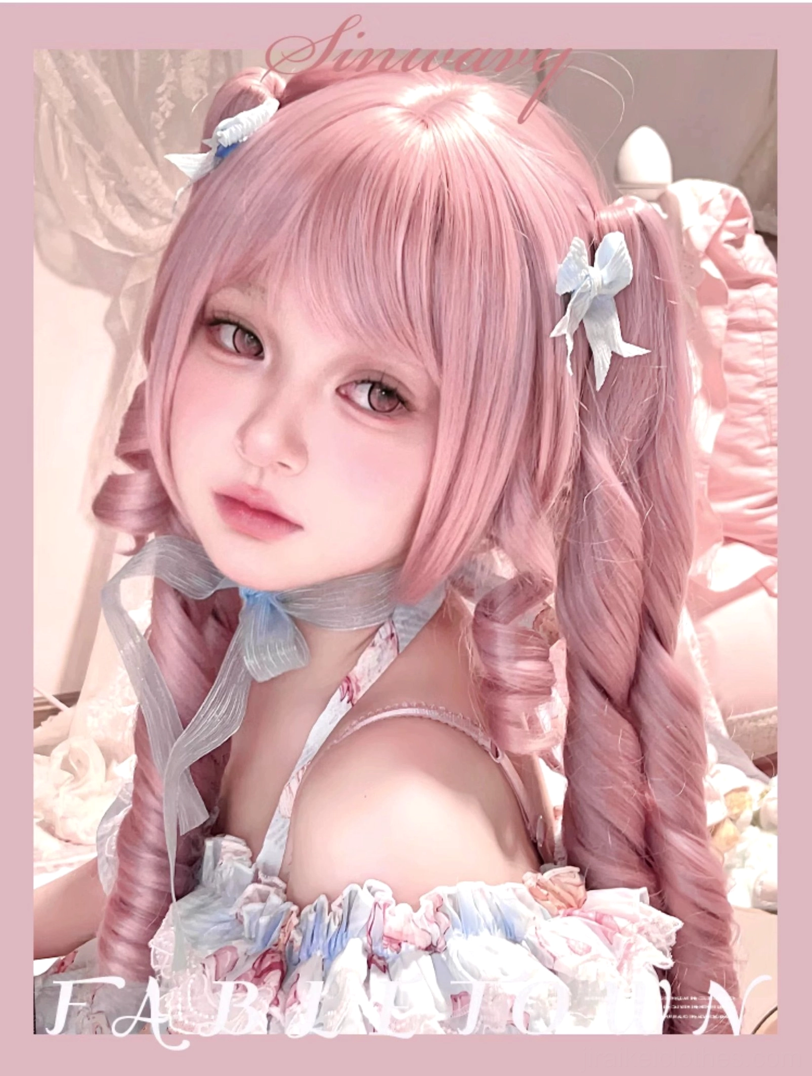 Front close-up portrait of sakura pink double ponytail Roman curl Lolita wig worn with air bangs and blue hair bows, showcasing ringlet curl detail in sweet bedroom background