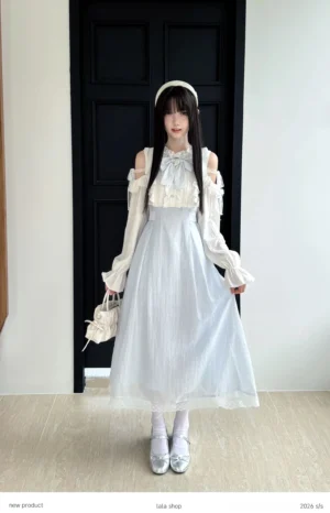 Seiso Kei cold-shoulder dress full front view featuring blue and white color block design with ruffled collar and long puff sleeves worn indoors