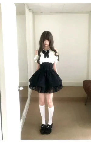 Complete Seiso Kei two-piece outfit displayed from front view in hallway interior, showing coordinated sweet lolita ensemble with knee-high white socks and black Mary Jane loafers
