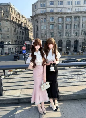 Seiso Kei two-piece mermaid fishtail skirt set with white off-shoulder blouse worn by female models on urban riverside street, showcasing pink and black skirt options