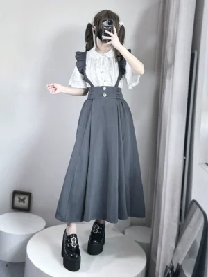 Grey high-waisted pleated seiso kei suspender skirt with ruffled straps full-body front view fitting room selfie