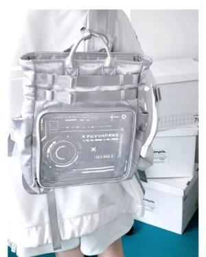 Silver cyberpunk Jirai Kei ita backpack worn on person showing back three-quarter view with clear anime badge display window and top carry handles on office background