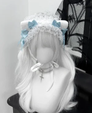 Sky blue fluffy cat ear jirai kei headband with white lace base and rhinestone embellishments front view on mannequin