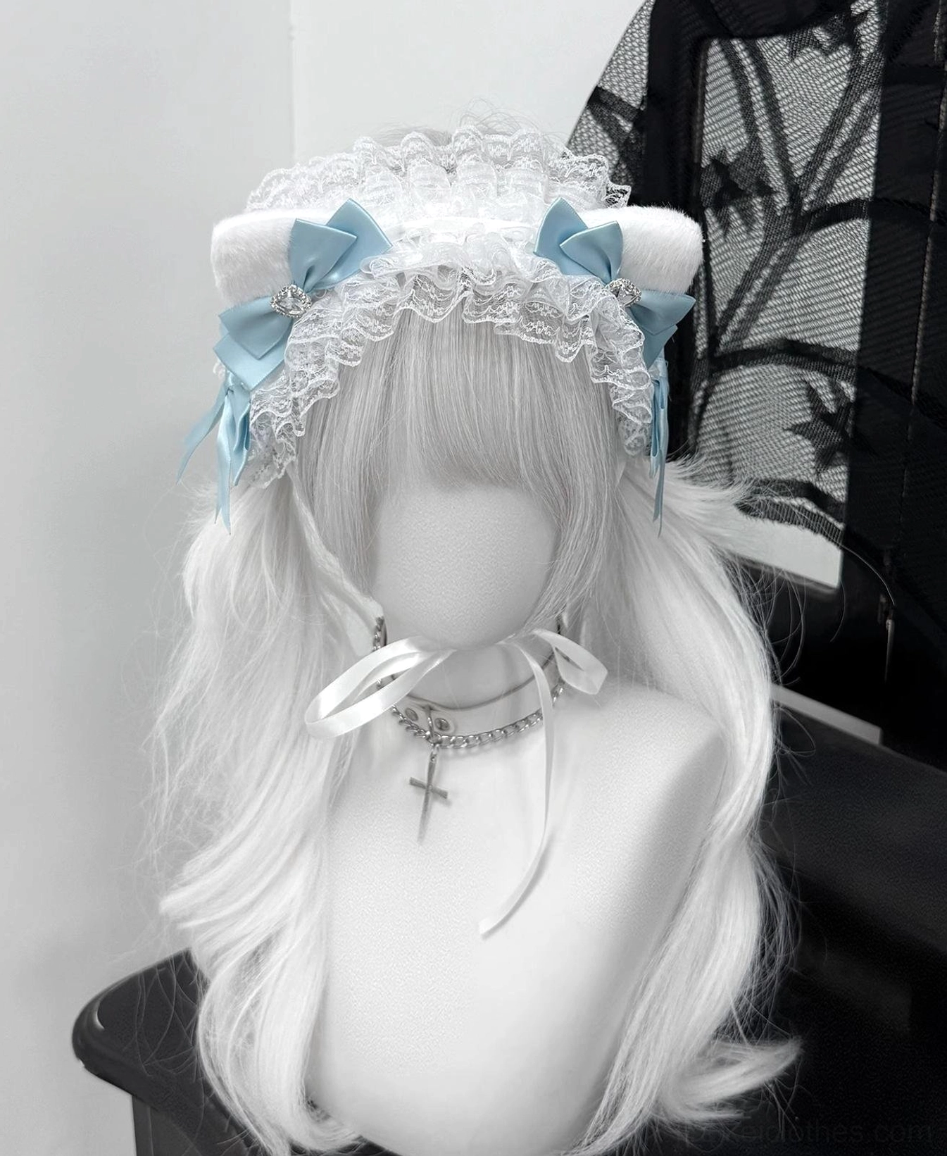 Sky blue fluffy cat ear jirai kei headband with white lace base and rhinestone embellishments front view on mannequin