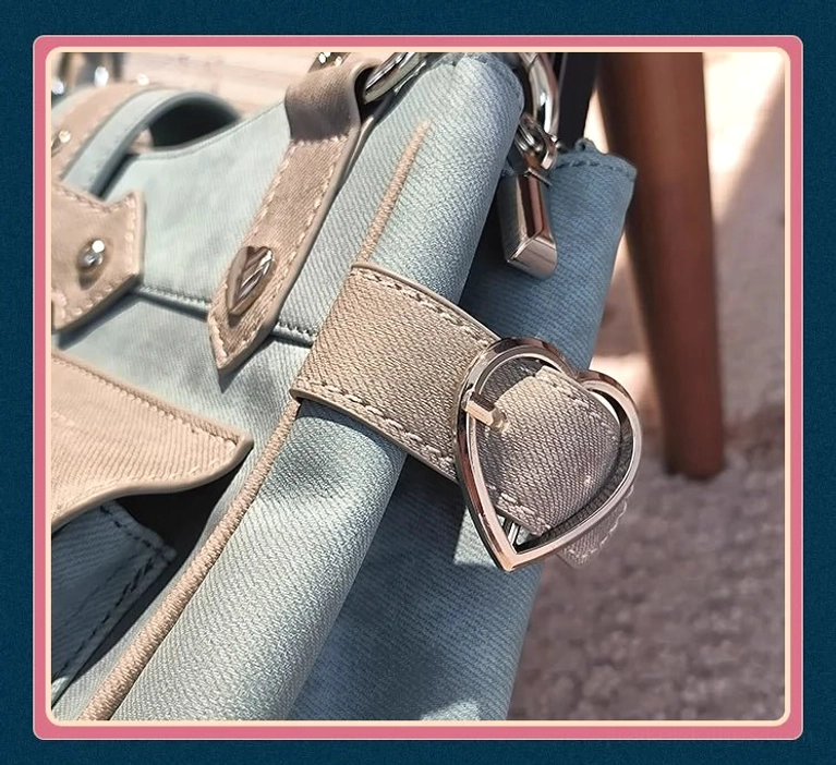 Sky blue Jirai Kei ita crossbody bag detailed front view with heart-shaped metal hardware and decorative elements prominently displayed, product detail photography