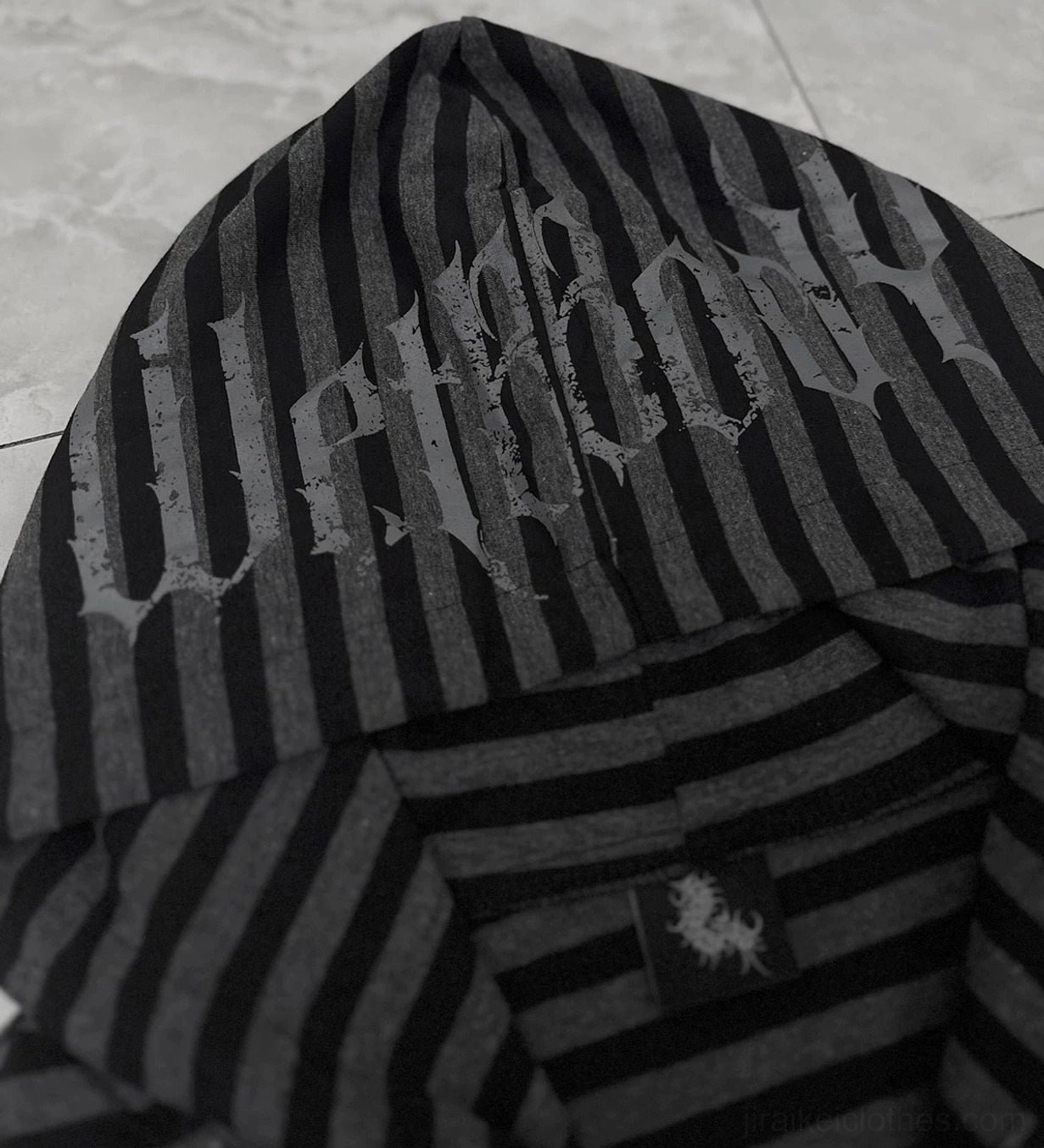Gothic striped hoodie close-up top-down view of hood showing gothic letter print and stripe knit fabric texture
