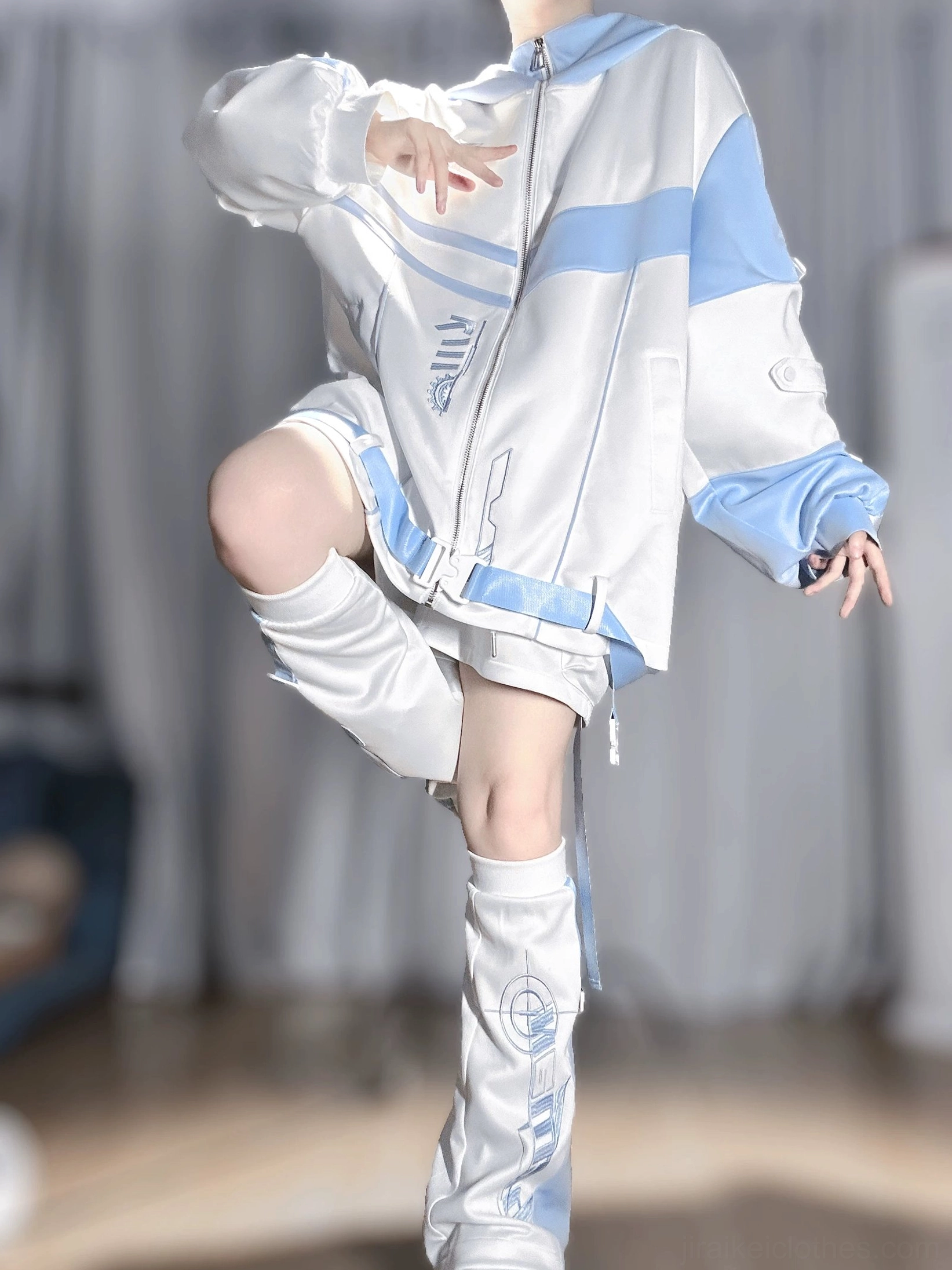 Techwear hoodie jacket low side view with bent knee pose, side printed patterns, relaxed oversized jacket fit, and coordinated shorts styling