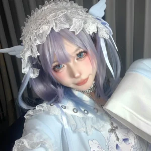 Tenshi angel wing lace headband with light blue ribbon worn by model with purple-blue gradient twin tails, close-up front view demonstrating white ruffled lace and delicate wing construction