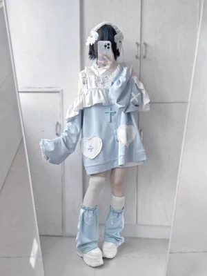 Tenshi Jirai Kei oversized cold-shoulder hoodie set with heart patches and cross ornaments worn by model in full-body front mirror pose with matching leg warmers and thigh-high socks