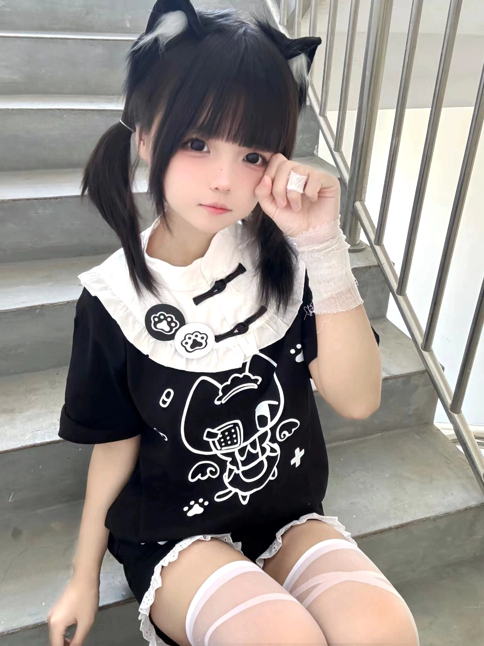 Black Tenshi Kaiwai cat-themed cotton T-shirt sitting front view with paw print details and wrist bandage aesthetic