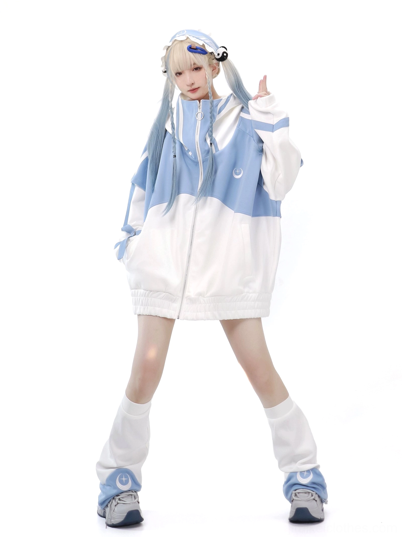 Tenshi Kaiwai blue-white color-block sports set with oversized zip hoodie featuring loose fit and crescent collar logo detail on blonde model full-body front view white studio