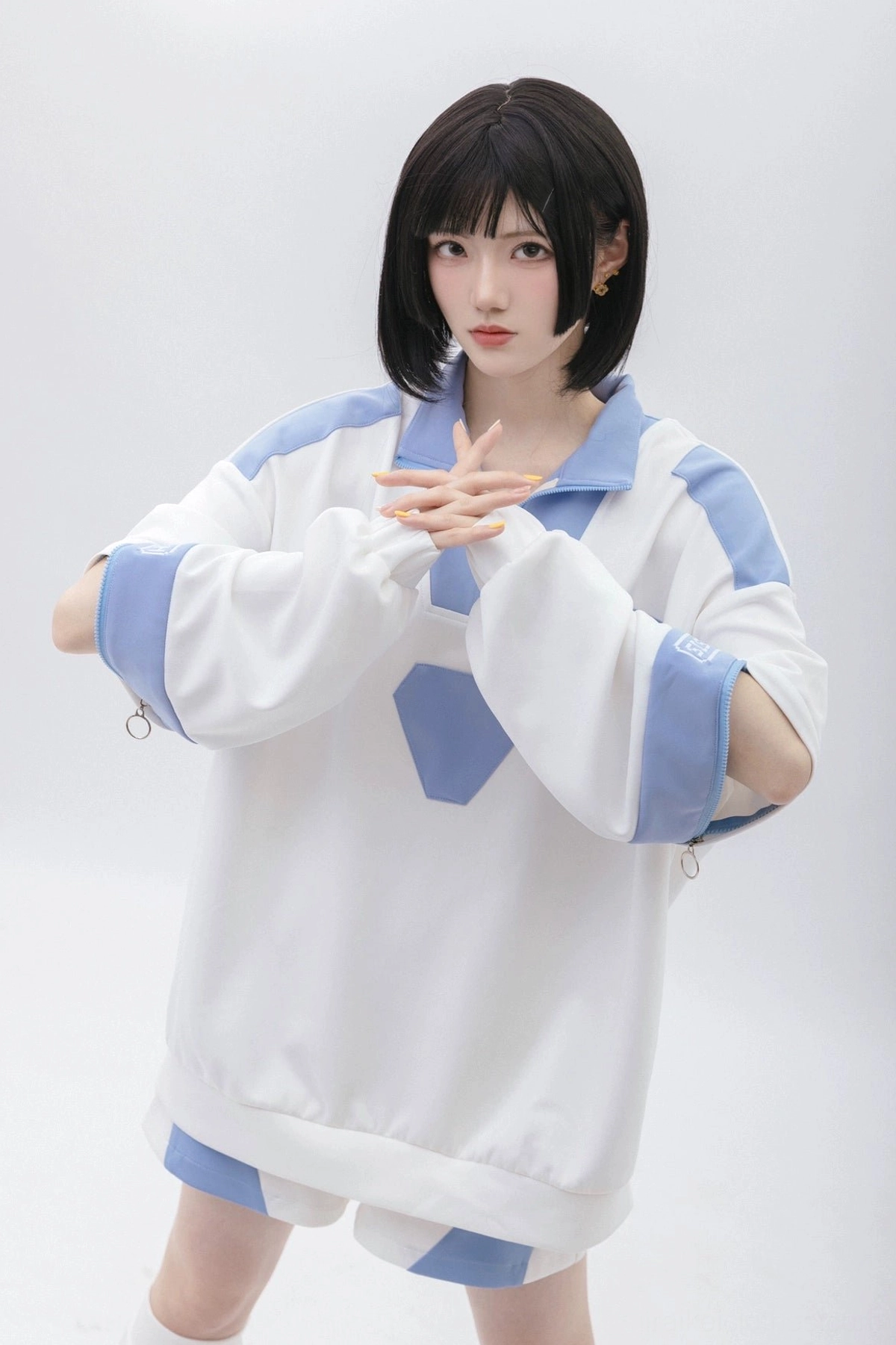 Blue and white Tenshi Kaiwai sweatshirt with detachable sleeves, polo collar, and geometric trim styling for alternative fashion enthusiasts