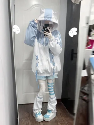 Tenshi Kaiwai blue and white cat-ear zip-up hoodie with cross lace-up front worn by model in indoor doorway setting front mirror selfie view