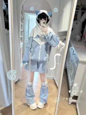 Tenshi Kaiwai detachable sleeve jacket with cat-ear hood and angel wing chest print paired with white shorts and striped leg warmers, front full-body mirror selfie showcasing light blue and white color-block design
