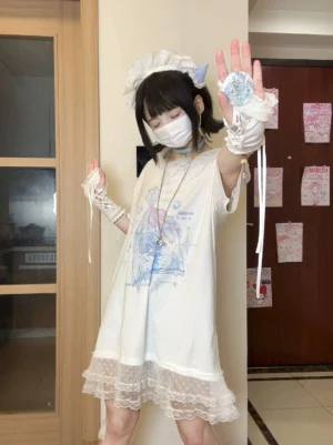 Oversized Tenshi Kaiwai printed T-shirt dress with delicate white lace hem and fingerless lace gloves, half front view, model wearing maid headdress and long pendant necklace indoors