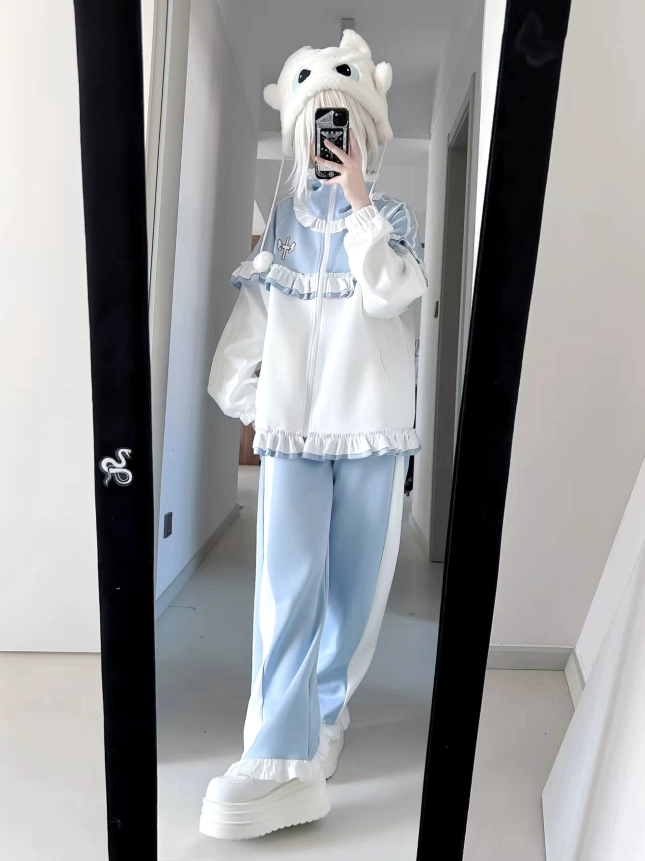 Tenshi Kaiwai ruffle tracksuit fabric detail showing polyester texture, frill construction and embroidery stitching quality