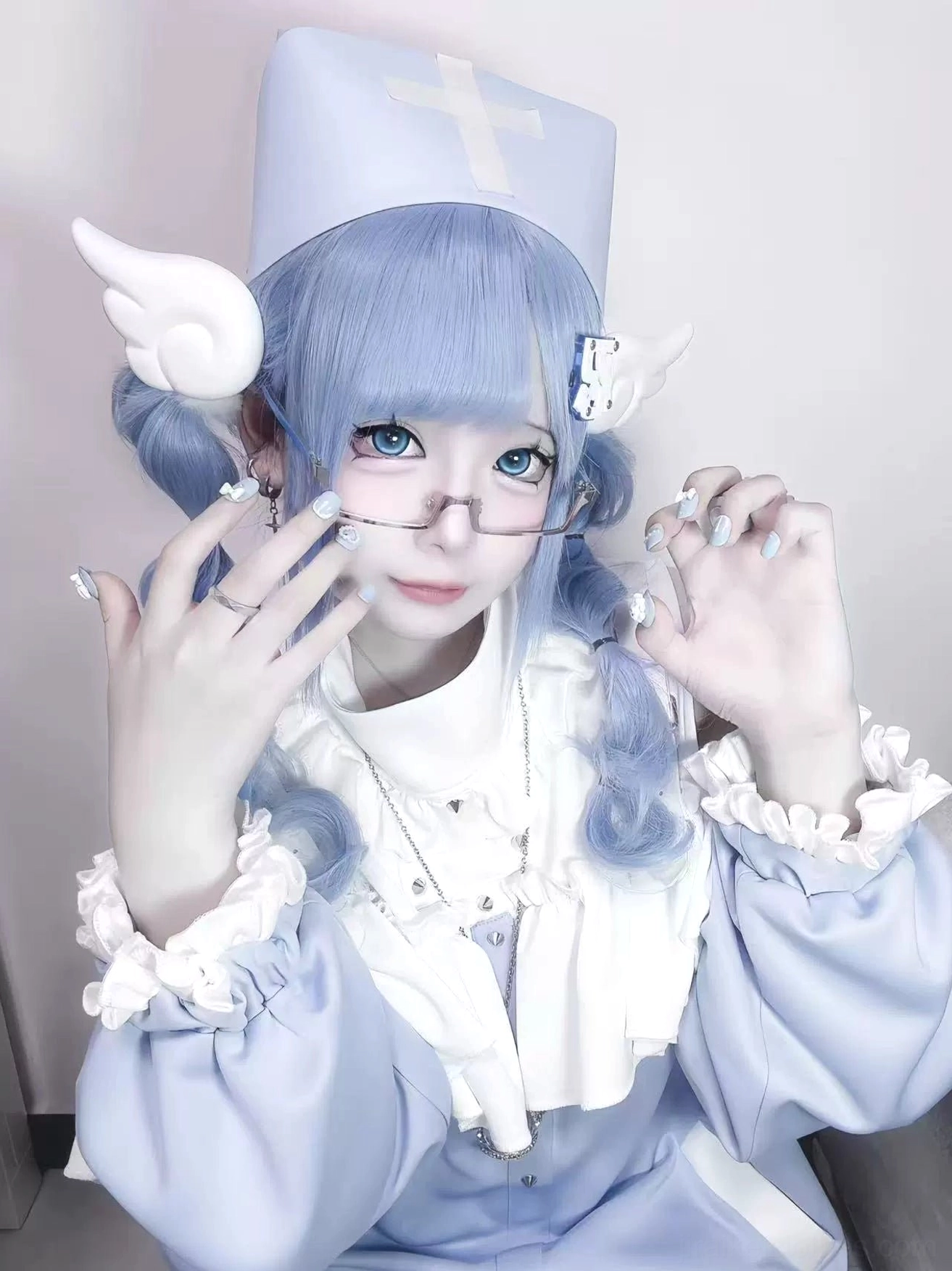 Close-up detail of Tenshi Kaiwai sweatshirt featuring ruffled cuffs, layered white collar, cross-patterned nurse hat, and blue braids
