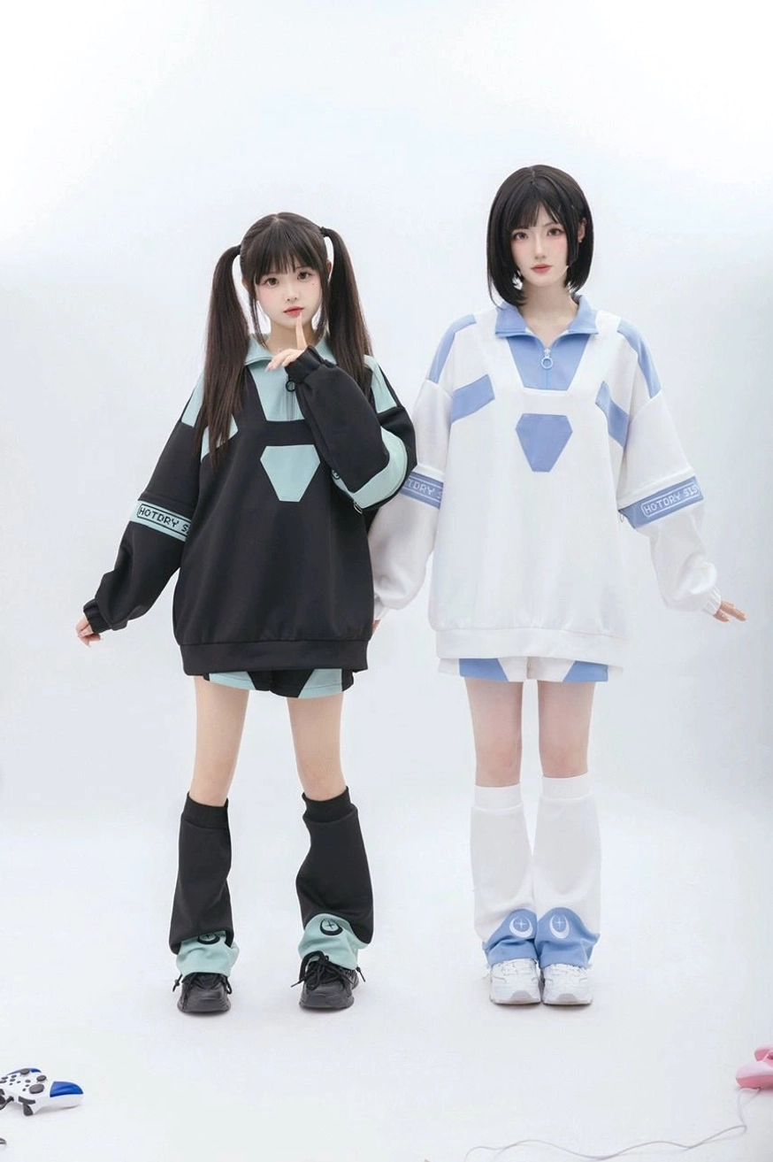 Tenshi Kaiwai removable sleeve sweatshirt and shorts set worn by two female models in full-body front standing view, showcasing both blue and white and black and green color options with geometric trim details