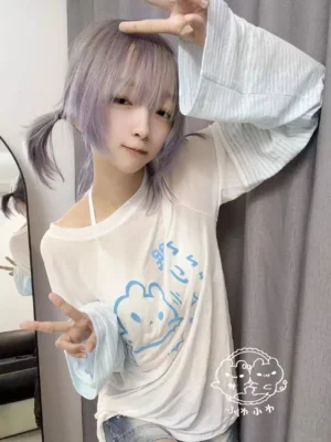Tenshi Kaiwai water blue striped cartoon print cover-up blouse front close-up view showing cute anime graphic with Japanese text on white lyocell base and light blue polyester sleeves worn by model with purple twin ponytails