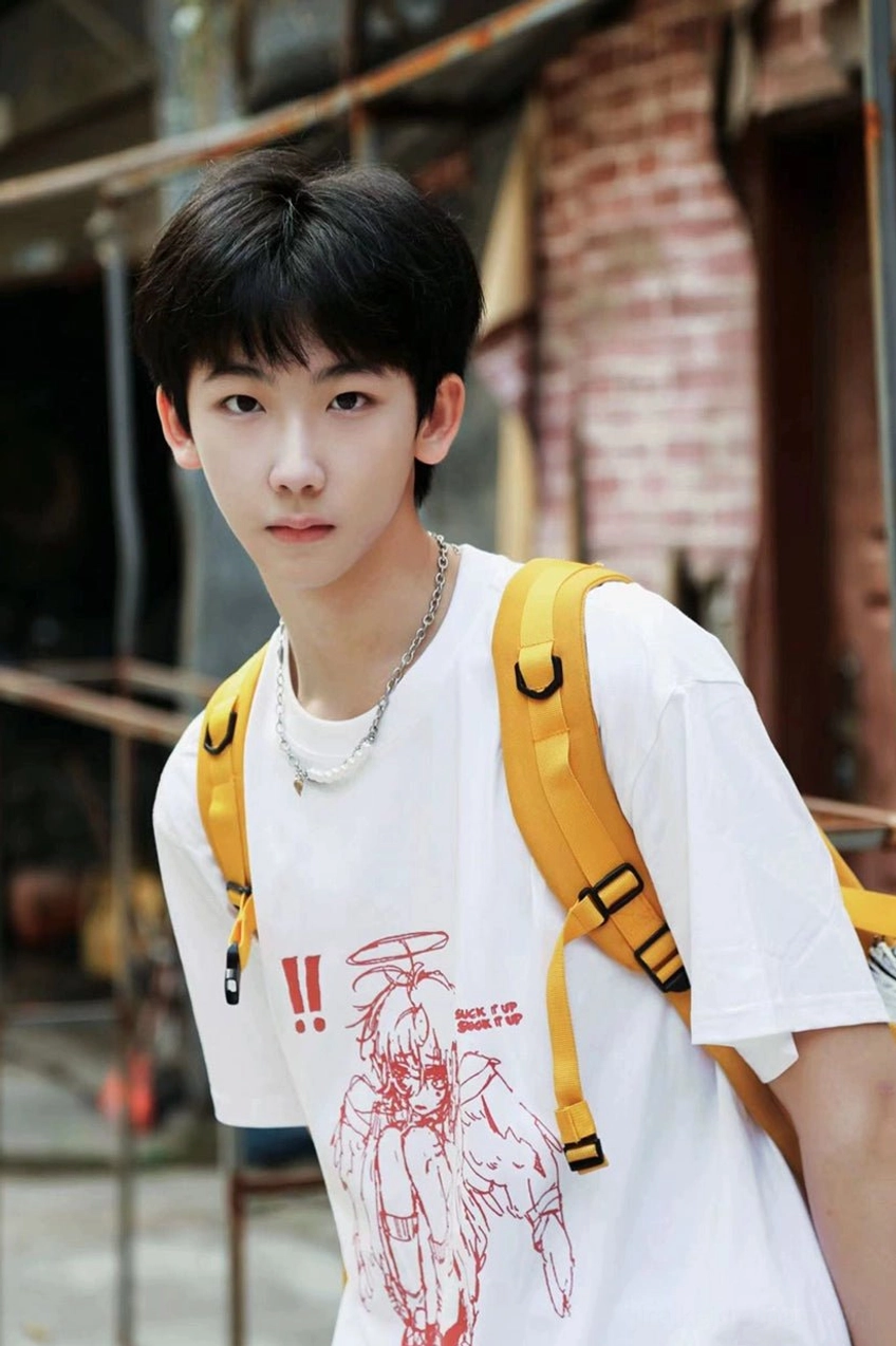Male model wearing white Tenshi Kaiwai crying angel graphic t-shirt industrial indoor background with accessories Jirai Kei streetwear