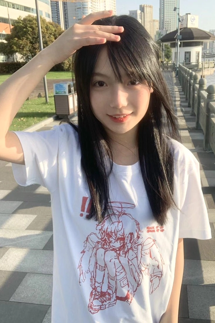 Female model wearing white Tenshi Kaiwai crying angel graphic t-shirt casual street bridge setting styling inspiration