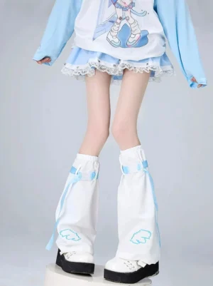 White Tenshi Kaiwai flared leg warmers with light blue trim and pixel wing embroidery, featuring blue ribbon cyber straps on female model in studio setting