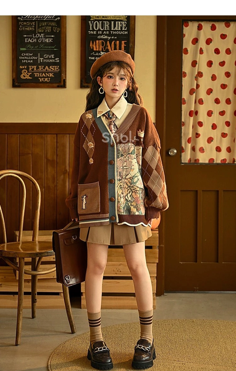 Vintage cardigan with decorative animal motifs and daisy prints showing design details and color palette