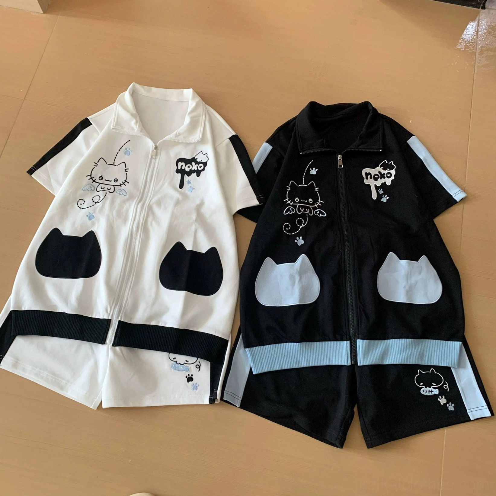 Twin-tailed model standing in front-facing mirror wearing white and black angel kitten Jirai Kei outfit with matched white socks and casual platform shoes complete styling