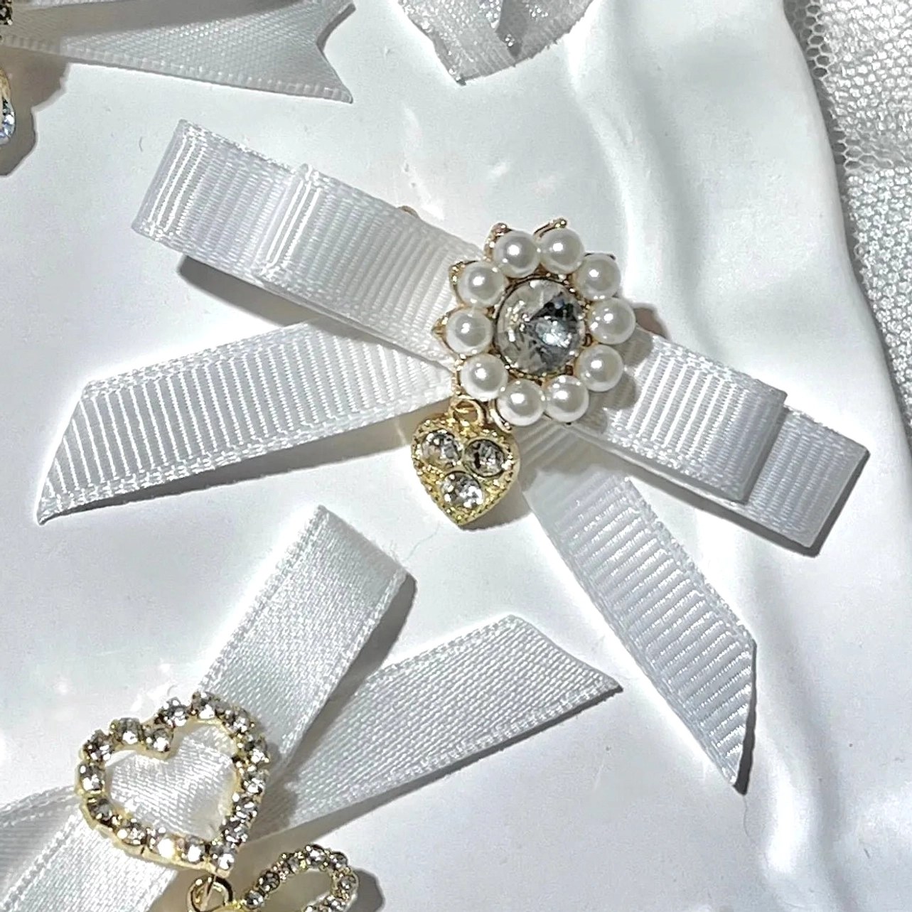 White bow pendant hair clips Jirai Kei fashion with delicate hanging pendant design and ornate rhinestone decoration