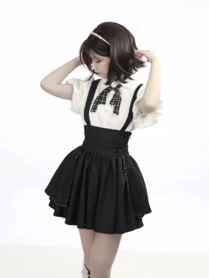 White puff sleeve bubble blouse with black suspender mini skirt full-body front view on model wearing plaid bow tie and black knee-high socks
