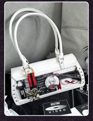 White croc texture itabag with clear display window and striped detachable strap top-down flat lay on dark background