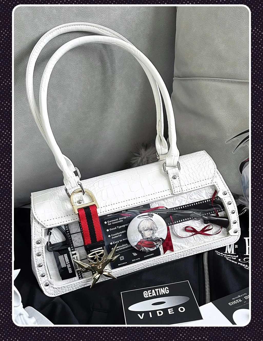 White croc texture itabag with clear display window and striped detachable strap top-down flat lay on dark background