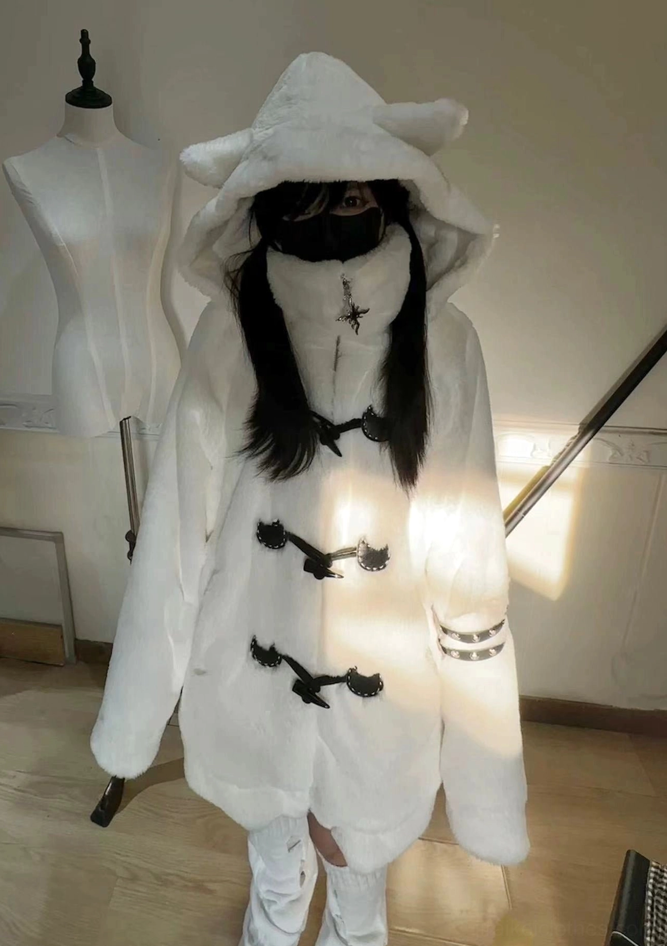 White fuzzy cat ear hooded coat full front view indoor stair area high collar horn toggles cross pendant ornament